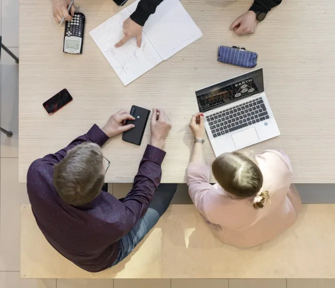 People of different genders working at the same table