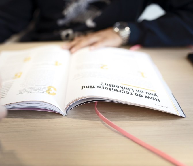 Henkilö katsoo Työkirjaa.