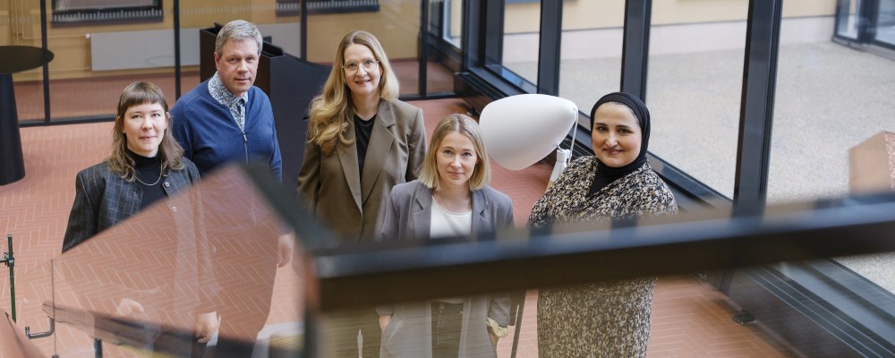 Swecon työntekijöitä seisoo portaikon alla ryhmänä.