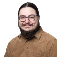 Portrait of Arash Badie-Modiri smiling with a white background.